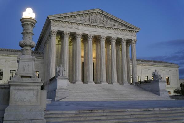 FILE - Light illuminates part of the Supreme Court building at dusk on Capitol Hill in Washington, Nov. 16, 2022. In courtrooms across America, defendants get additional prison time for crimes that juries found they didn’t commit. The Supreme Court is being asked, again, to put an end to the practice.(AP Photo/Patrick Semansky, File)