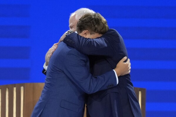 Gus Walz tearfully cheers on his father as he accepts