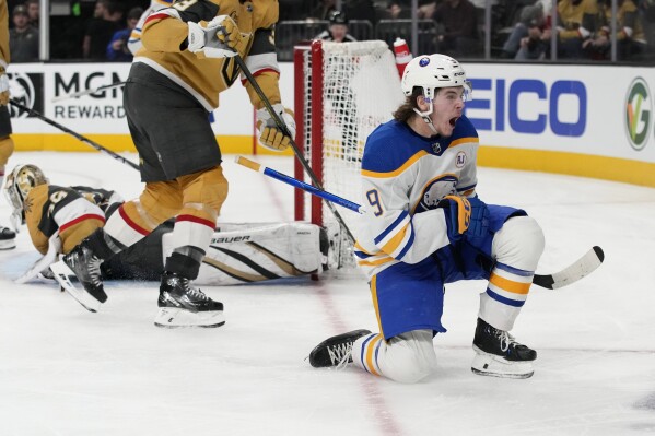 Buffalo Sabres left wing Zach Benson (9) celebrates after scoring against the the Vegas Golden Knights during the third period of an NHL hockey game Friday, Dec. 15, 2023, in Las Vegas. (AP Photo/John Locher)