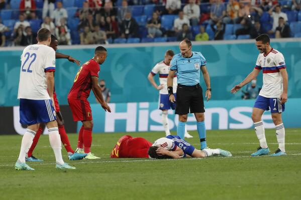 Belgium's Timothy Castagne, left, and Russia's Daler Kuzyayev, grimace in pain on the pitch after injuring during a header during the Euro 2020 soccer championship group B match between Belgium and Russia at the Saint Petersburg stadium in St. Petersburg, Russia, Saturday, June 12, 2021. (Anatoly Maltsev/Pool via AP)