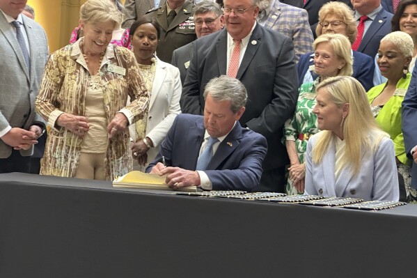 Georgia Gov. Brian Kemp signs the budget for the year beginning July 1, 2024 at the state capitol in Atlanta on Tuesday, May 7, 2024. Kemp says the document shows Georgia can boost spending and cut taxes at the same time. (AP Photo/Jeff Amy)