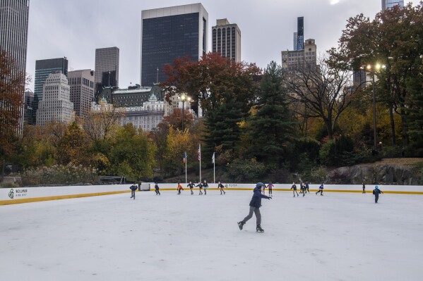 People participate in free skating at the opening of Wollman skating rink in Central Park on Sunday, Nov. 14, 2021, in New York. (AP Photo/Brittainy Newman)