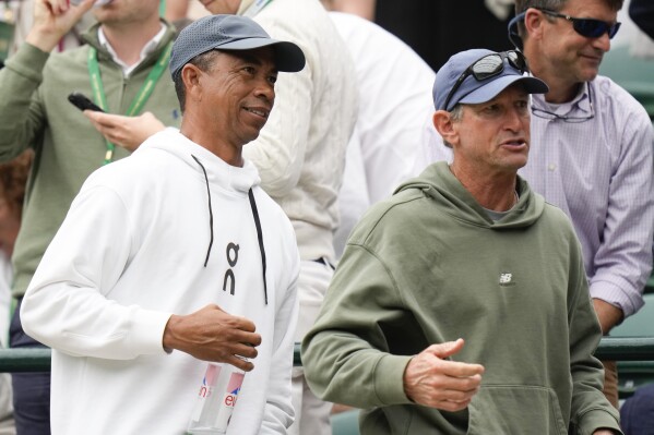Bryan Shelton, left, father Ben Shelton of the United States leaves the stands following his son's third round match against Denis Shapovalov of Canada at the Wimbledon tennis championships in London, Saturday, July 6, 2024. (AP Photo/Alberto Pezzali)