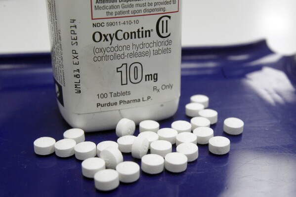 FILE - In this Feb. 19, 2013 file photo, OxyContin pills are arranged for a photo at a pharmacy in Montpelier, Vt. Companies and U.S. government entities have agreed to settlements of lawsuits over the toll of opioids totaling more than $50 billion. (AP Photo/Toby Talbot, File)