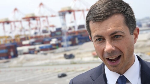 U.S. Secretary of Transportation Pete Buttigieg speaks during an interview with selected media members after walking around at Yokohama Port during a tour which includes a visit to a construction site for a new pier that will accommodate larger ships coming from the U.S. on Monday, June 19, 2023, in Tokyo. (AP Photo/Eugene Hoshiko)