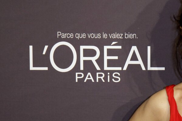 FILE - In this file photo dated Wednesday, May 23, 2012, the L'Oreal logo at the 65th international film festival, in Cannes, southern France. In a statement issued Saturday June 27, 2020, French cosmetics giant L’Oreal says it will remove words like “whitening” from its skin care products following criticism of the company amid global protests against racism. (AP Photo/Francois Mori, FILE)