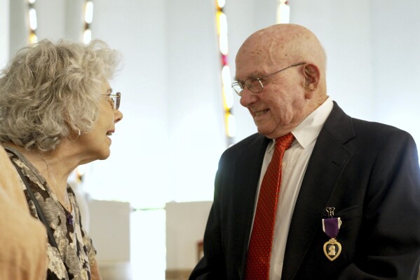Earl Meyer wears his freshly awarded Purple Heart medal for combat injuries he received while serving in the Korean War, Friday, May 17, 2024 in St. Peter, Minn. (AP Photo/Mark Vancleave)