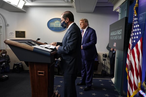 President Donald Trump listens as Health and Human Services Secretary Alex Azar prepares to speak during a news conference in the briefing room at the White House in Washington, Friday, Nov. 20, 2020. (AP Photo/Susan Walsh)