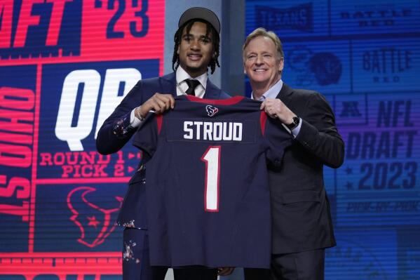 Ohio State quarterback C.J. Stroud, left, poses beside NFL Commissioner Roger Goodell after being chosen by the Houston Texans with the second overall pick during the first round of the NFL football draft, Thursday, April 27, 2023, in Kansas City, Mo. (AP Photo/Jeff Roberson)