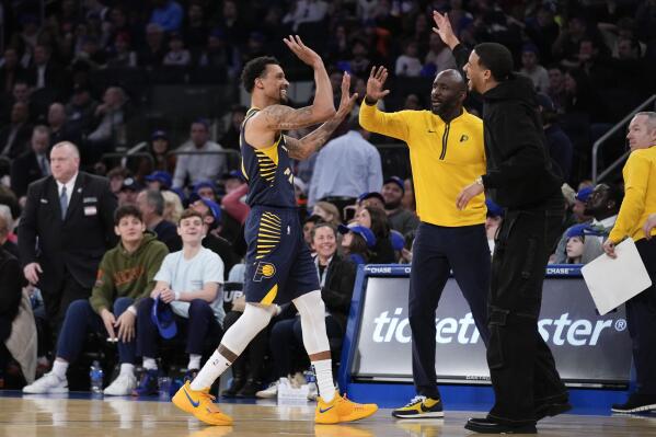 Indiana Pacers' George Hill, left, reacts after hitting a half court shot during the first half of an NBA basketball game against the New York Knicks, Sunday, April 9, 2023, in New York. (AP Photo/Seth Wenig)