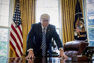 
              FILE - In this Friday, April 21, 2017, file photo, President Donald Trump poses for a portrait in the Oval Office in Washington. Trump will mark the end of his first 100 days in office with a flurry of executive orders as he looks to fulfill campaign promises and rack up victories ahead of that milestone. (AP Photo/Andrew Harnik, File)
            
