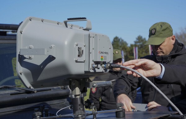 In this photo provided by the Serbian Interior Ministry, Serbian Gendarmerie officers show the U.S.-made Long Range Acoustic Device (LRAD) – which is illegal in Serbia and many other countries, in Belgrade, Serbia, Wednesday, March 19, 2025. (Serbian Ministry of Interior via AP)