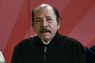 FILE - Nicaragua's President Daniel Ortega poses for a photo during the ALBA Summit at the Palace of the Revolution in Havana, Cuba, Tuesday, Dec. 14, 2021. A new study released Wednesday, Nov. 29, 2023 says that about half of Nicaragua's population of 6.2 million want to leave their homeland because of a mix of economic decline and repression from President Daniel Ortega's government. The study said that 23% considered themselves “very prepared” to emigrate. (Adalberto Roque, Pool Photo via AP, file)