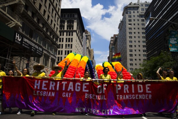 The Heritage of Pride group carry banners and balloons during the New York City Pride Parade on June 25, 2017 in New York. (AP Photo/Michael Noble Jr., file)