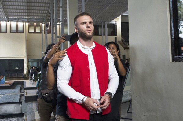 British citizen Thomas Parker, who is accused of drug offenses, walks to a holding cell after his trial hearing at a district court in Denpasar, Bali, Indonesia, Tuesday, May 20, 2025. (AP Photo/Firdia Lisnawati)