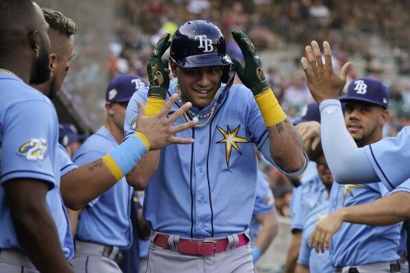 Tampa Bay Rays' Jose Siri is greeted in the dugout after his two-run home run during the second inning of a baseball game against the Detroit Tigers, Friday, Aug. 4, 2023, in Detroit. (AP Photo/Carlos Osorio)