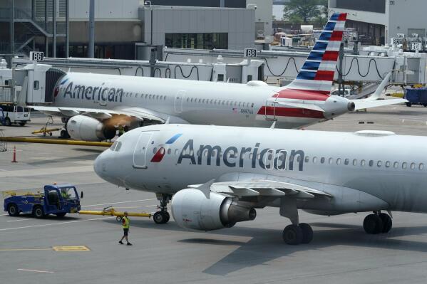 American Airlines passenger jets prepare for departure, Wednesday, July 21, 2021, near a terminal at Boston Logan International Airport, in Boston. American Airlines Group Inc. (AAL) on Thursday, July 22 reported second-quarter net income of $19 million, after reporting a loss in the same period a year earlier. (AP Photo/Steven Senne)
