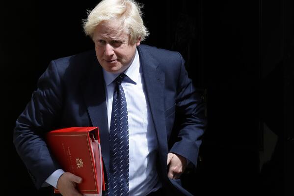 FILE - Britain's Foreign Secretary Boris Johnson leaves a cabinet meeting at 10 Downing Street after the general election in London, Tuesday, June 13, 2017. The British government is facing a Thursday deadline to hand over a sheaf of former Prime Minister Boris Johnson’s personal messages to the country’s COVID-19 pandemic inquiry. (AP Photo/Frank Augstein, File)
