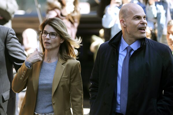In this April 3, 2019, photo, Lori Loughlin, left, arrives at federal court in Boston with her attorney Sean Berkowitz to face charges in a nationwide college admissions bribery scandal. Berkowitz, a former federal prosecutor, has a reputation for being fearless, yet cool-headed and a master at navigating complex cases. (AP Photo/Steven Senne)