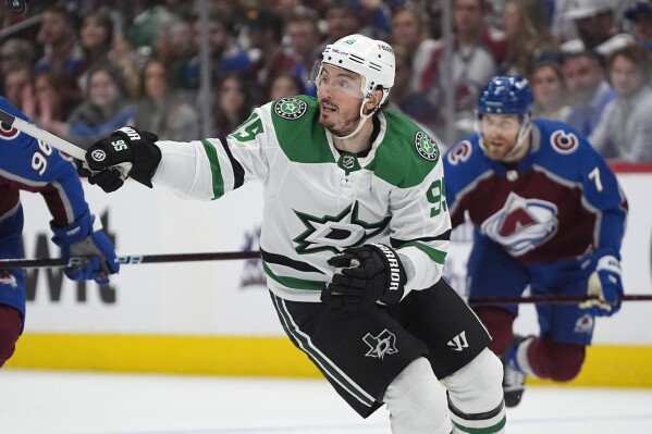 Dallas Stars center Matt Duchene, front, pursues the puck, in front of Colorado Avalanche defenseman Devon Toews during the second period of Game 6 of an NHL hockey playoff series Friday, May 17, 2024, in Denver. (AP Photo/David Zalubowski)