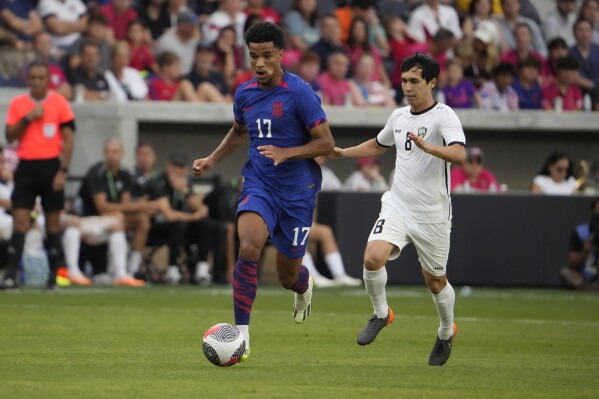 United States' Malik Tillman (17) brings the ball down the pitch as Uzbekistan's Jamshid Iskanderov (8) defends during the second half of an international friendly soccer match Saturday, Sept. 9, 2023, in St. Louis. (AP Photo/Jeff Roberson)
