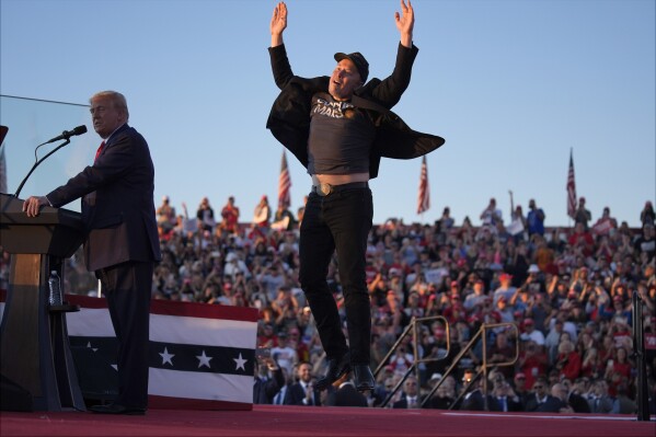 Elon Musk jumps on the stage as Republican presidential nominee former President Donald Trump speaks at a campaign rally at the Butler Farm Show, Oct. 5, 2024, in Butler, Pa. (AP Photo/Evan Vucci, File)