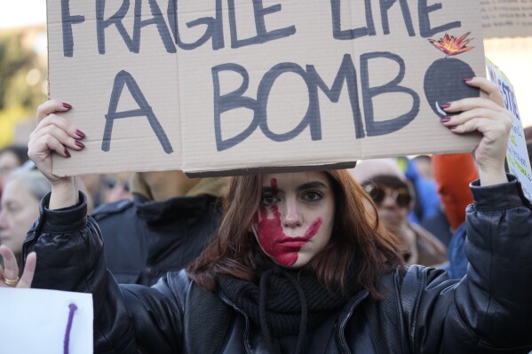 A woman shows a banner during a demonstration on the occasion of International Day for the Elimination of Violence against Women, in Milan, Italy, Saturday, Nov.25, 2023. Thousands of people are expected to take the streets in Rome and other major Italian cities as part of what organizers call a 