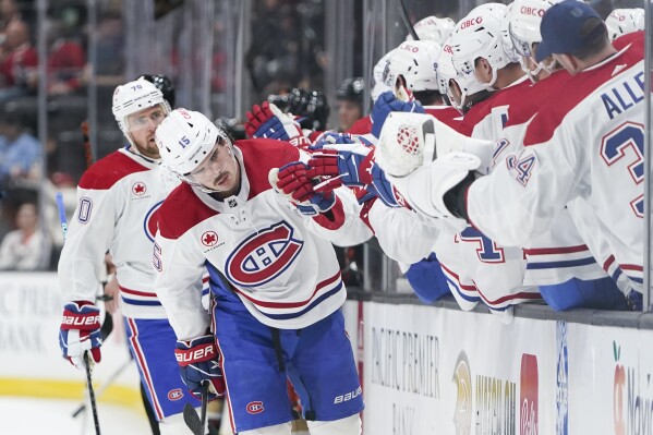 Montreal Canadiens center Alex Newhook (15) celebrates with the bench after scoring during the first period of an NHL hockey game against the Anaheim Ducks Wednesday, Nov. 22, 2023, in Anaheim, Calif. (AP Photo/Ryan Sun)