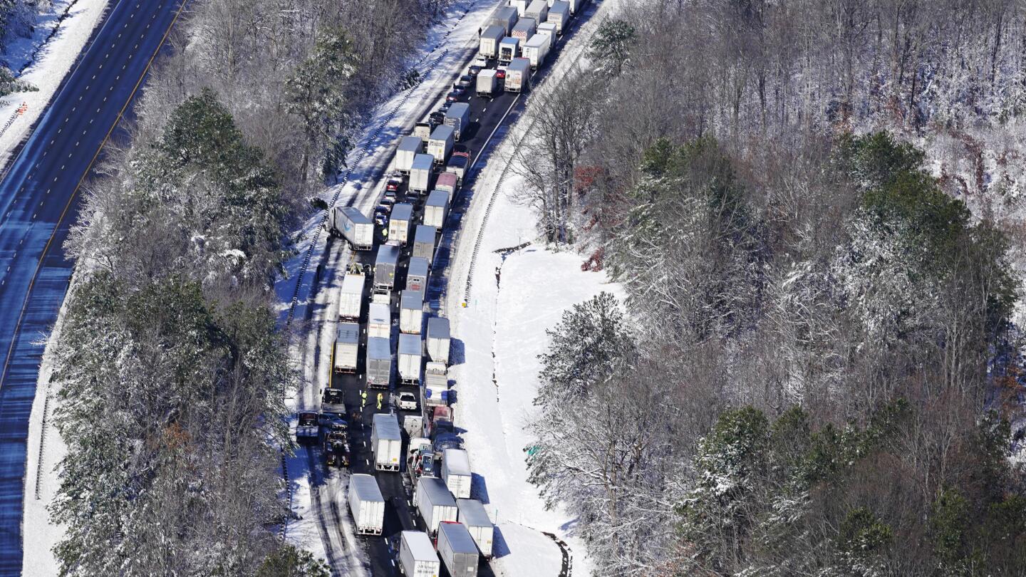 Drivers fret about food and fuel while stranded on highway | AP News