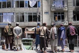 Taliban fighters gather at the site of an explosion in front of a Sikh temple in Kabul, Afghanistan, Saturday, June 18, 2022. Several explosions and gunfire ripped through a Sikh temple in Afghanistan's capital. (AP Photo/Ebrahim Noroozi)