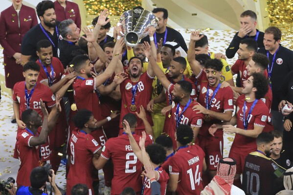Qatar's team lift the trophy after winning the AFC Asian Cup final match between Qatar and Jordan at the Lusail Stadium in Lusail, Qatar, Saturday, Feb. 10, 2024. (APPhoto/Hussein Sayed)