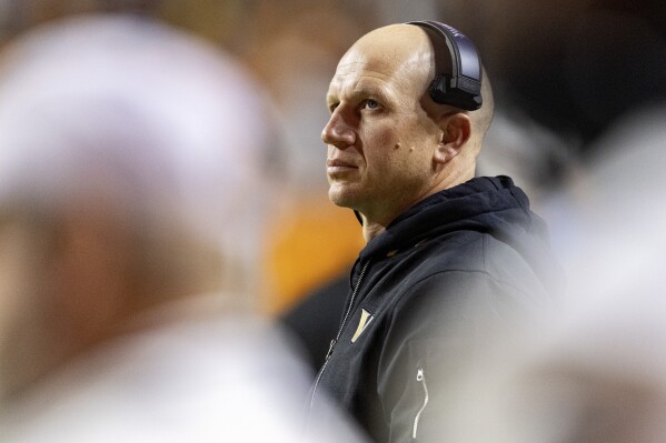 Vanderbilt head coach Clark Lea watches a jumbotron during the second half of an NCAA college football game against Tennessee, Saturday, Nov. 25, 2023, in Knoxville, Tenn. (AP Photo/Wade Payne)