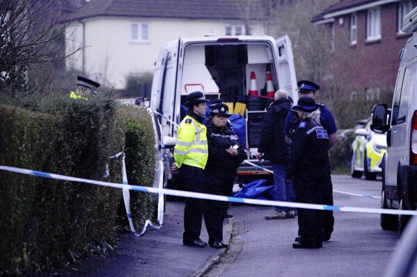 Police work at the scene in Blaise Walk, in Sea Mills, Bristol, England, where a woman has been arrested on suspicion of murder after three children were found dead at a property, Sunday, Feb. 18, 2024. The Avon and Somerset Police force said officers were called to a house in the Sea Mills area of Bristol shortly after midnight and found the three children inside. It said a 42-year-old woman is in police custody at a hospital. (Ben Birchal/PA via AP)
