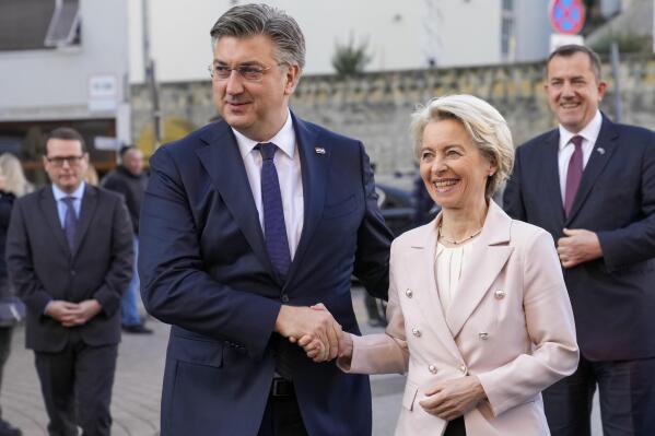 Croatia's Prim Minister Andrej Plenkovic shakes hands with Ursula von der Leyen, President of the European Commission, in Zagreb, Croatia, Sunday, Jan. 1, 2023. Croatia switched to the shared European currency, the euro, and removed dozens of border checkpoints to join the world's largest passport-free travel area. (AP Photo/Darko Bandic)