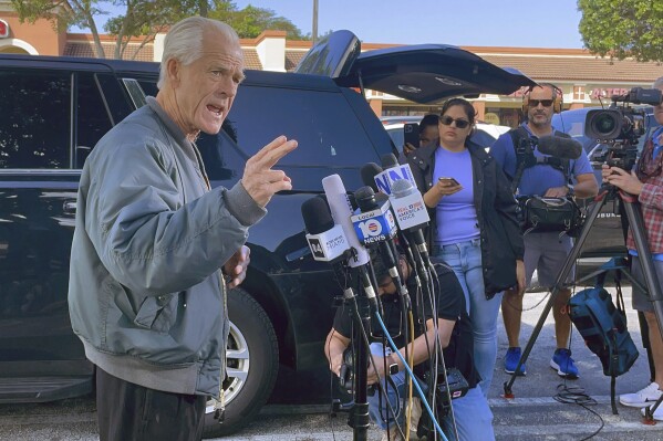 Former Trump White House official Peter Navarro speaks to reporters before he heads to prison, Tuesday, March 19, 2024 in Miami, to begin serving his sentence for refusing to cooperate with a congressional investigation into the Jan. 6, 2021, attack on the U.S. Capitol. (AP Photos/Adriana Gomez Licon)