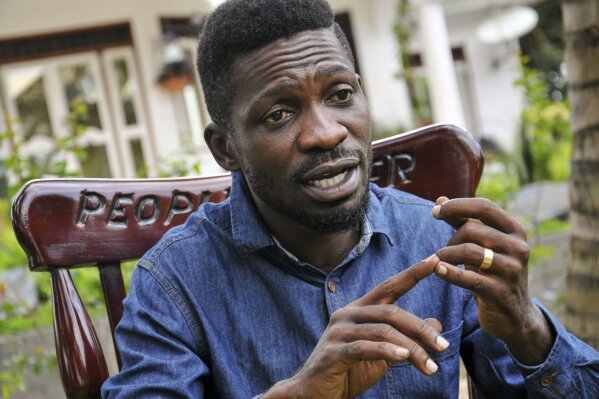 FILE - In this Friday, March 27, 2020 file photo, Ugandan musician, lawmaker and presidential aspirant Bobi Wine, whose real name is Kyagulanyi Ssentamu, speaks to The Associated Press in Kampala, Uganda. Police in Uganda have confronted opposition presidential candidate Bobi Wine during an online press conference, and he says they fired tear gas and bullets as they swarmed his car. Journalists watched Thursday, Jan. 7, 2021 as an officer appeared to drag Wine from the car while he pleaded that he had broken no law. (AP Photo/Ronald Kabuubi, File)
