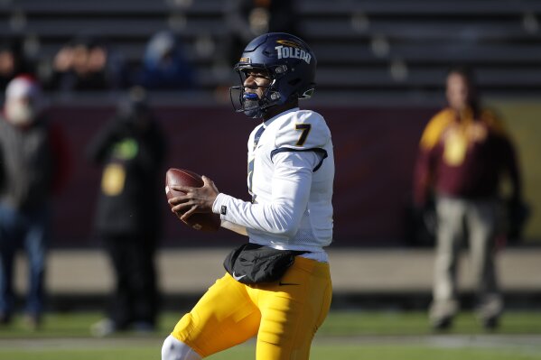 Toledo quarterback Dequan Finn (7) looks to pass against Central Michigan during the first half of an NCAA college football game, Friday, Nov. 24, 2023, in Mount Pleasant, Mich. (AP Photo/Al Goldis)