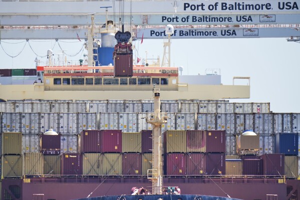 A crane lifts a container from the cargo ship Epaminondas at the Port of Baltimore, Wednesday, April 9, 2025, in Baltimore. (AP Photo/Stephanie Scarbrough)