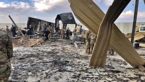 U.S. soldiers and journalists inspect the rubble at a site of Iranian bombing, in Ain al-Asad air base, Anbar, Iraq, Monday, Jan. 13, 2020. Ain al-Asad air base was struck by a barrage of Iranian missiles on Wednesday, in retaliation for the U.S. drone strike that killed atop Iranian commander, Gen. Qassem Soleimani, whose killing raised fears of a wider war in the Middle East. (AP Photo/Qassim Abdul-Zahra)