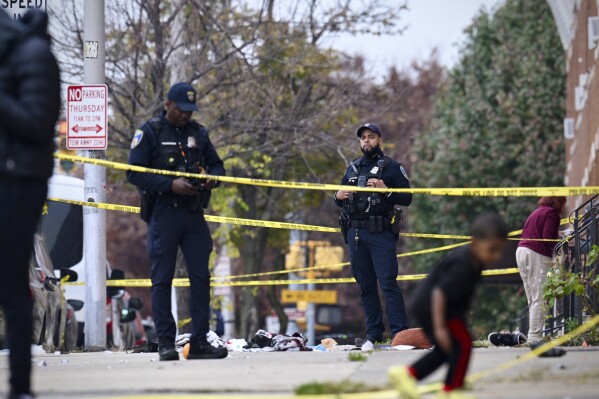 Baltimore City Police officers work in the 2600 block of Wilkens Avenue in the Milhill neighborhood, of southwest Baltimore, on Tuesday, Nov. 7, 2023. Body camera recordings released on Friday, Nov. 17, show four officers fired three dozen shots, killing Hunter Jessup, who appeared to fire his own weapon before he was struck by gunfire. (Jerry Jackson/The Baltimore Sun via AP)