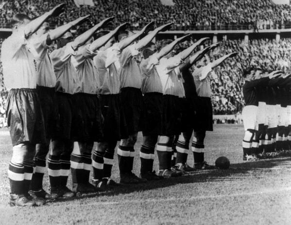 FILE - In this May 14, 1938 file photo the England soccer team give the Nazi salute before the start of their game against Germany in front of a record crowd of over 100,000 at the Olympic Stadium in Berlin. England defeated Germany 6-3. One of the great rivalries in international soccer will be renewed on Tuesday at the European Championship when England plays Germany in the round of 16 at Wembley Stadium. The teams have played some epic matches in the past, including in the 1966 World Cup final and in the semifinals at Euro '96. They each won one of those matches, but overall the Germans lead with 15 victories, 13 losses and four draws.(AP Photo)