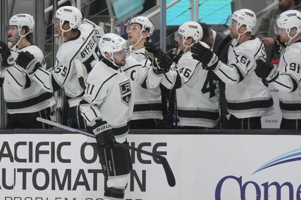 Los Angeles Kings center Anze Kopitar, foreground, is congratulated by teammates after scoring against the San Jose Sharks during the first period of an NHL hockey game in San Jose, Calif., Tuesday, Dec. 19, 2023. (AP Photo/Jeff Chiu)