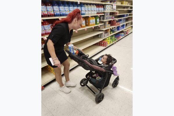 This undated photo provided by Deatrie Young shows Jazmin Valentine and her baby at a supermarket. Valentine filed a federal lawsuit Tuesday, Sept. 27, 2022, alleging that nurses and staff at the Washington County jail in Maryland ignored her screams and plea for help as she gave birth to her daughter there in July 2021. (Deatrie Young via AP)