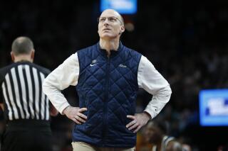 FILE - Akron head coach John Groce looks up from the bench during the first half of a first-round NCAA college basketball tournament game against UCLA, Thursday, March 17, 2022, in Portland, Ore. Akron extended coach John Groce's contract through the 2029-30 season on Wednesday, April 27, 2022. (AP Photo/Craig Mitchelldyer, File)