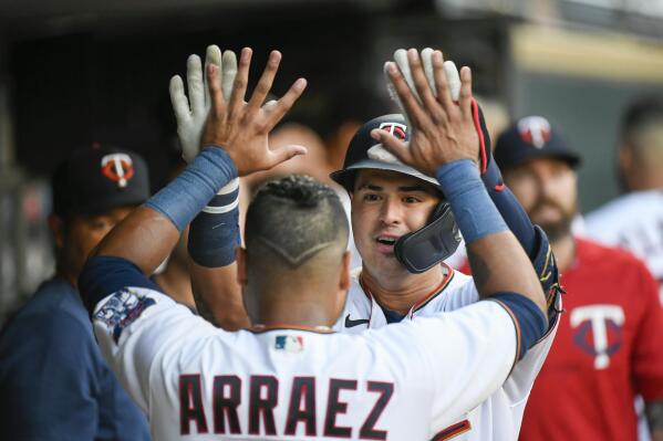 Minnesota Twins' Jose Miranda, right, celebrates with Luis Arraez after hitting a home run against the Texas Rangers during the first inning of a baseball game Friday, Aug. 19, 2022, in Minneapolis. (AP Photo/Craig Lassig)
