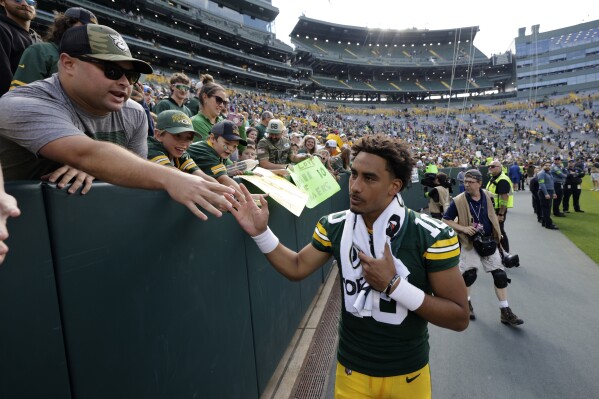 Green Bay Packers quarterback Jordan Love (10) greets fans after a preseason NFL football game against the Seattle Seahawks, Saturday, Aug. 26, 2023, in Green Bay, Wis. The Packers won 19-15. (AP Photo/Mike Roemer)
