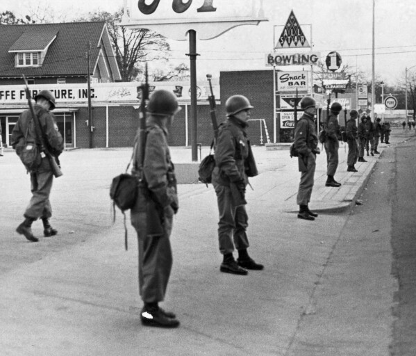 South Carolina National Guard surround a shopping center in Orangeburg, S.C., Feb. 8, 1968, after African-American students from South Carolina State College rioted the night before after being denied entrance to a bowing alley (background). (AP Photo/Dave Martin)