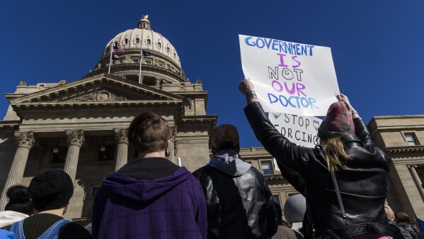 FILE - People gather in front of the Idaho Statehouse in opposition to anti-transgender legislation moving through an Idaho Republican congress, Friday, Feb. 24, 2023, in Boise, Idaho. The U.S. Supreme Court's decision on Monday, April 15, 2024, allows the state to put in place a 2023 law that subjects physicians to up to 10 years in prison if they provide hormones, puberty blockers or other gender-affirming care to people under age 18. A federal judge in Idaho had previously blocked the law in its entirety. (Darin Oswald/Idaho Statesman via AP, File)