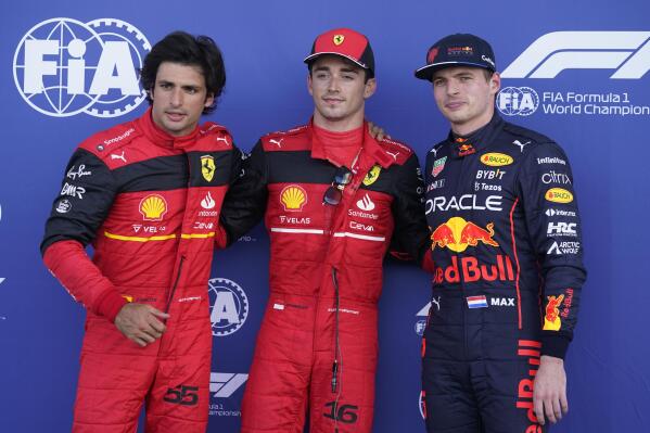 From left, second place Ferrari driver Carlos Sainz of Spain, pole position starter Ferrari driver Charles Leclerc of Monaco and third place Red Bull driver Max Verstappen of the Netherlands pose for a photo following qualifying for the Formula One Miami Grand Prix auto race at the Miami International Autodrome, Saturday, May 7, 2022, in Miami Gardens, Fla. (AP Photo/Darron Cummings)