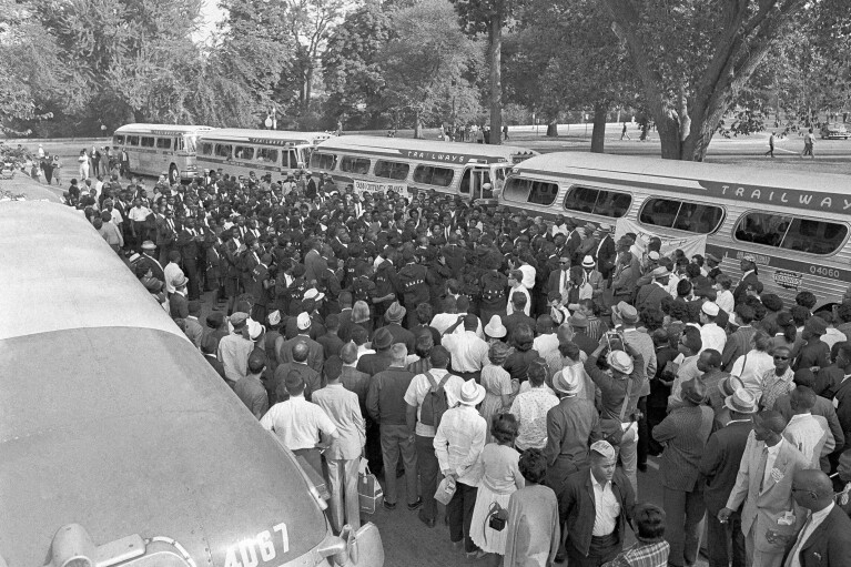 FILE - Members of the NAACP from Wilmington, N.C., sing in the street near the Washington monument grounds, Aug. 28, 1963 after their arrival to participate in the March on Washington. (AP Photo/File)